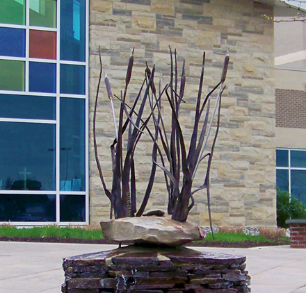 Artist blacksmith fountain with forged cattails